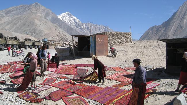 Uyghur women selling silk rugs in northwest China.