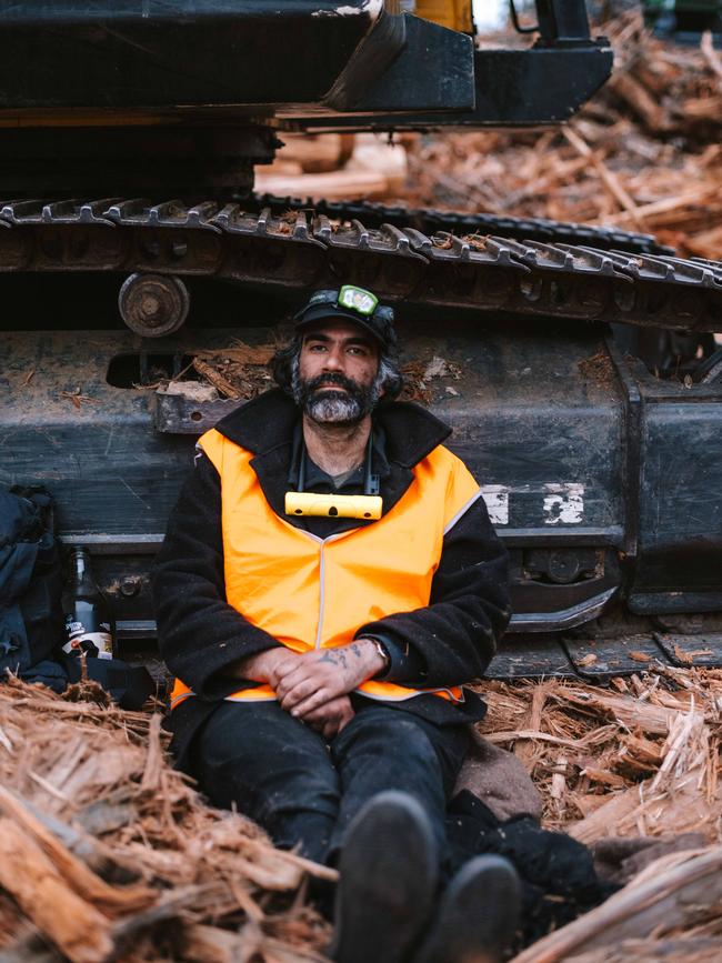 Activist Ali Alishah chained to a bulldozer in a logging coupe in the Styx Valley, northeast of Hobart. Picture: Bob Brown Foundation