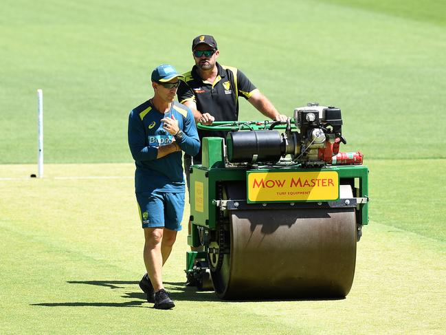 Australian coach Justin Langer (left) inspects the pitch as and curator Brett Sipthorpe looks on during the Australian cricket team training session at Perth Stadium in Perth, Thursday, December 13, 2018.  Australia are preparing for the second Test match against India at Perth Stadium on Friday. (AAP Image/Dave Hunt) NO ARCHIVING, EDITORIAL USE ONLY