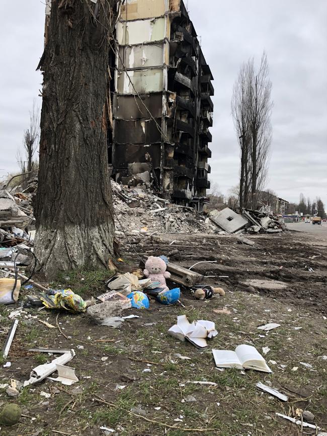 Children's toys left outside of a burnt out apartment block Borodyanka. April, 2022.