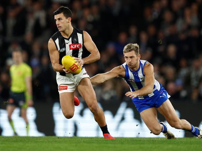 Nick Daicos of the Magpies evades Will Phillips. Picture: Michael Willson/AFL Photos via Getty Images.