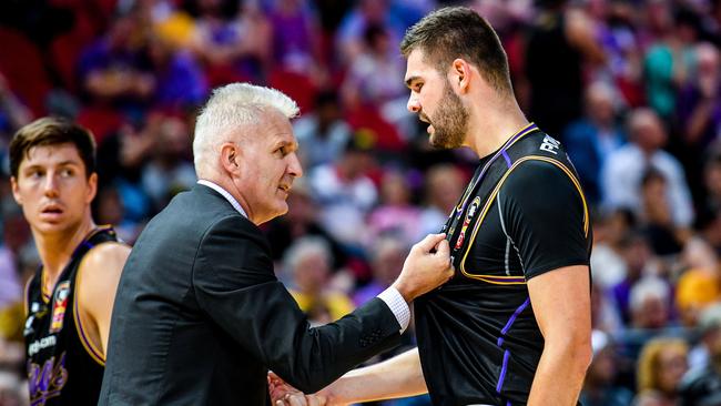 Andrew Gaze grabs Isaac Humphries during a timeout.