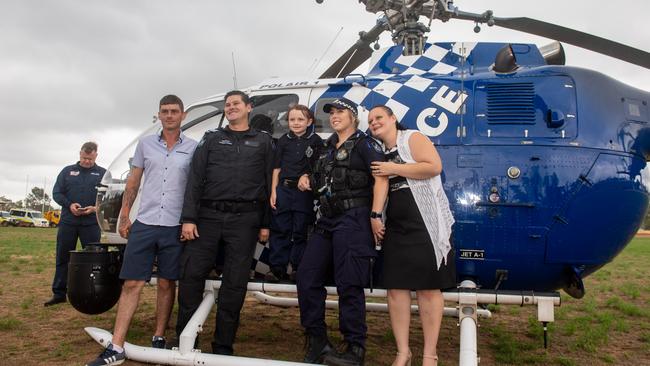 John Torry with sergeant Cameron Bourke, Savannah Burns, constable Kimberly Allen and Johanne Burns with the Polair police helicopter. PHOTO: Ali Kuchel