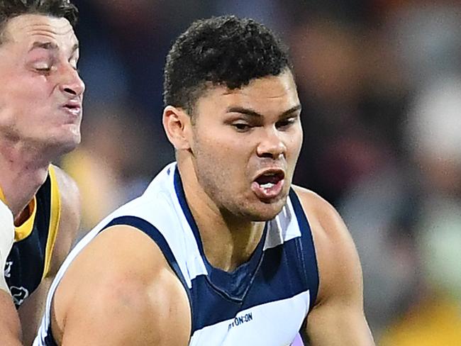 GEELONG, AUSTRALIA - JUNE 28: Brandan Parfitt of the Cats handballs whilst being tackled by Matt Crouch of the Crows during the round 15 AFL match between the Geelong Cats and the Adelaide Crows at GMHBA Stadium on June 28, 2019 in Geelong, Australia. (Photo by Quinn Rooney/Getty Images)