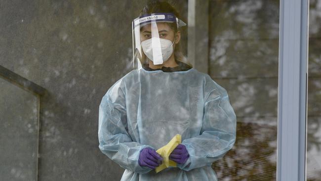 A worker in full PPE cleans surfaces at Arcare Maidstone Aged Care on Tuesday. Picture: NCA NewsWire/Andrew Henshaw