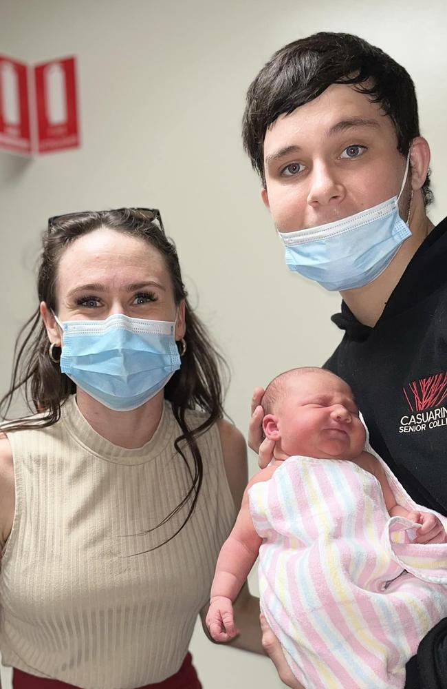 18-year-old Kingsley 'Junior' Alley holding his newborn daughter Eleanor, with stepmum Kylie Simmonds. Kingsley was allegedly murdered at Palmerston on October 8, 2022.