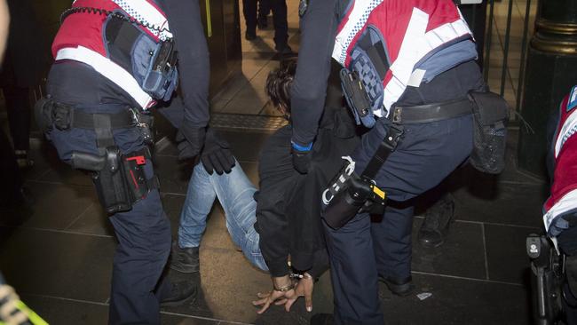 A man is arrested during White Night at Flinders St Station, unrelated to later youth violence. Picture: Jason Edwards