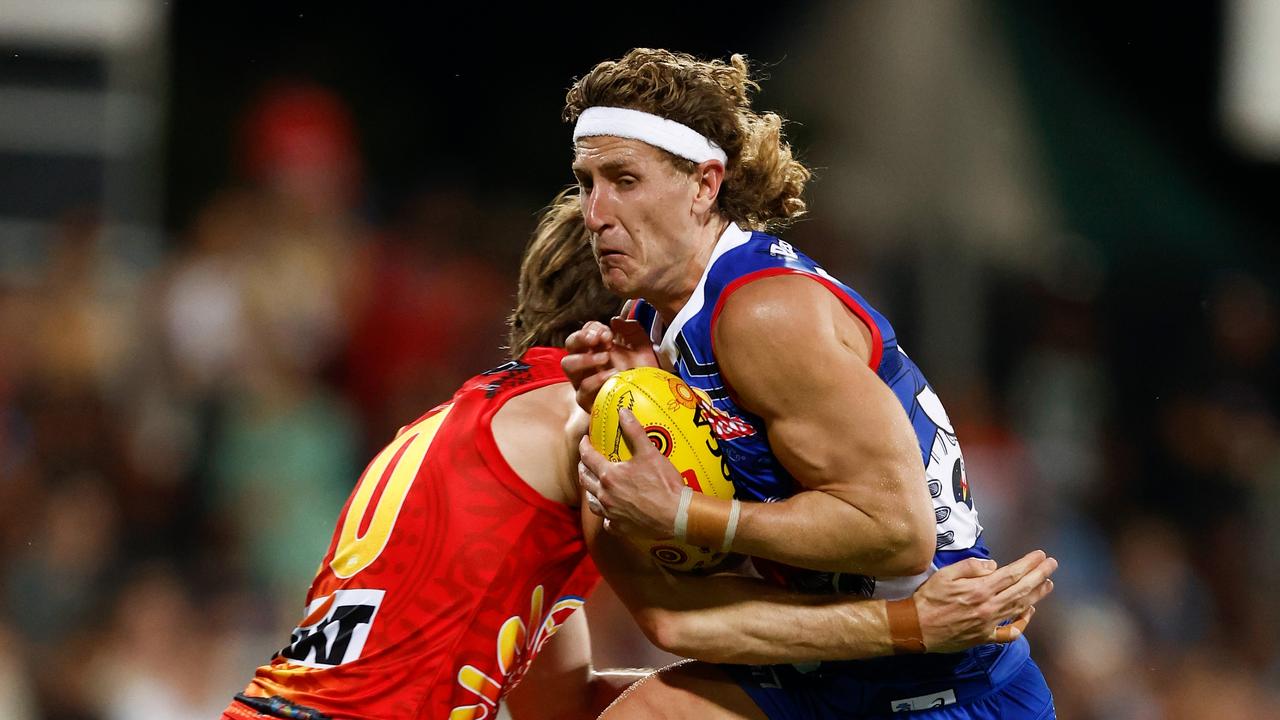 Aaron Naughton of the Bulldogs is tackled by Charlie Ballard of the Suns during the 2023 AFL Round 11 match between the Gold Coast Suns and the Western Bulldogs at TIO Stadium. (Photo by Michael Willson/AFL Photos via Getty Images)