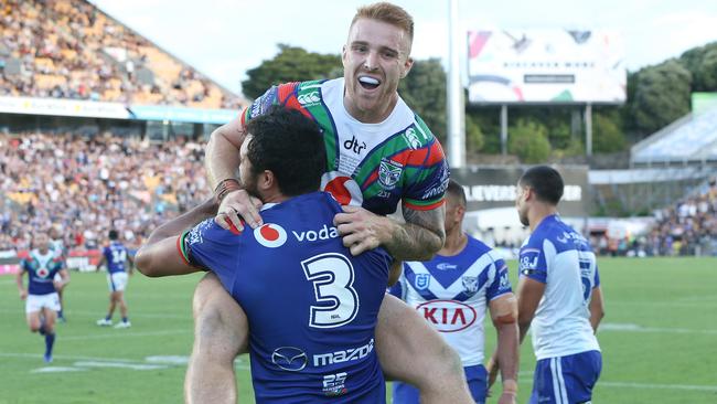 Adam Keighran (top) congratulates Peta Hiku of the Warriors on scoring a try during the Round 1 NRL match between the Warriors and the Canterbury-Bankstown Bulldogs at Mt Smart Stadium in Auckland, New Zealand, Saturday, March 16, 2019. (AAP Image/David Rowland) NO ARCHIVING, EDITORIAL USE ONLY