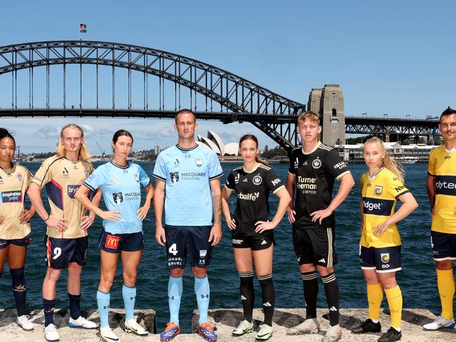 SYDNEY, AUSTRALIA - NOVEMBER 21:  (L-R) Chris Ikonomidis of the Macarthur Bulls, Bel Rolley and Lachie Rose of the Newcastle Jets, Shea Connors and Jordan Courtney-Perkins of the Sydney FC, Cushla Rue and Zac Sapsford of the Western Sydney Wanderers, Taylor Ray and Trent Sainsbury of the Central Coast Mariners pose during the A-League Unite Round press conference at Blues Point Reserve on November 21, 2024 in Sydney, Australia. (Photo by Matt King/Getty Images)