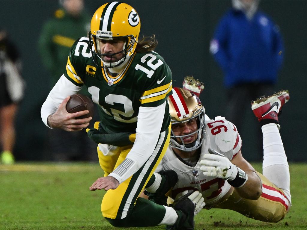 Aaron Rodgers is tackled by 49ers defensive end Nick Bosa. He was sacked five times in the Packers’ playoffs loss, which tied a post-season career high. Picture: Quinn Harris/Getty Images