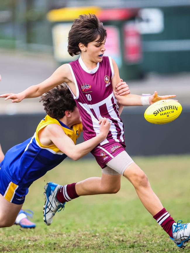 Queensland's Jorjai Triandos is tackled by his ACT opponent on day two of the championships. Picture: Tom Huntley