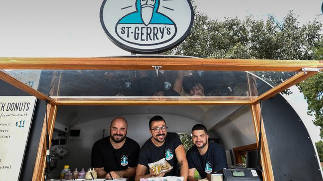 Dean Giannakis, owner of St Gerry’s food truck, in Caulfield Park with Manos Maroudis and Michal Zapantis. Picture: Penny Stephens