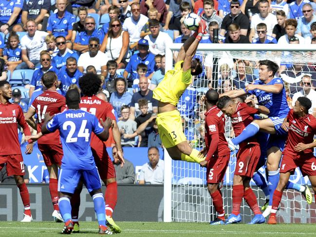 Liverpool's goalkeeper Alisson, centre, shows he is much better with his hands than his feet with this fine save against Leicester City. Picture: AP Photo