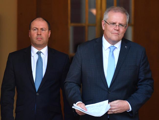 Treasurer Josh Frydenberg and Prime Minister Scott Morrison arrive to announce the government's $130b wage subsidy package at a press conference at Parliament House in Canberra, Monday, March 30, 2020. (AAP Image/Mick Tsikas) NO ARCHIVING