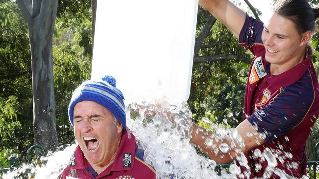 Lions AFL coach Chris Fagan gets dunked by Eric Hipwood. Picture: Liam Kidston