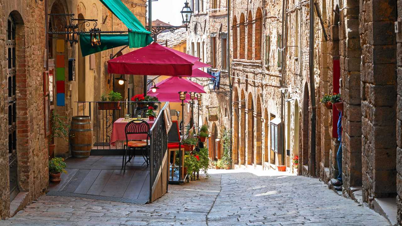 The charming narrow streets of Volterra in Tuscany and below right, the medieval palace Palazzo Dei Priori. Picture: baratroli