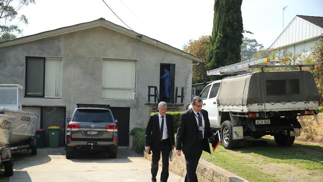 Detectives leaving the house as a forensic officer continues the investigation at the doorway where Pearce was shot. Picture: Tim Hunter.