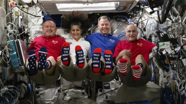 Astronauts Butch Wilmore, Suni Williams, Nick Hague and Don Pettit show their US flag-themed socks aboard the International Space Station last month. Picture: NASA/AP