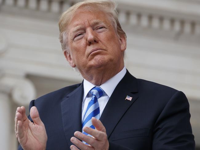President Donald Trump applauds during a Memorial Day ceremony at Arlington National Cemetery, Monday, May 28, 2018, in Arlington, Va. (AP Photo/Evan Vucci)