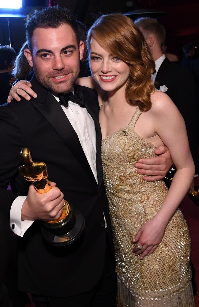 Emma Stone with brother Spencer celebrate her Best Actress win at the Governors Ball in Hollywood. Picture: AFP/Angela Weiss