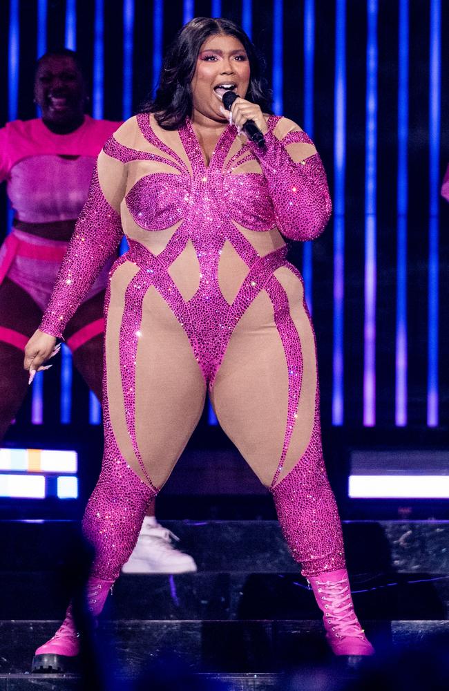 Lizzo shows off her famous curves in skimpy sports bra and exercise leggings