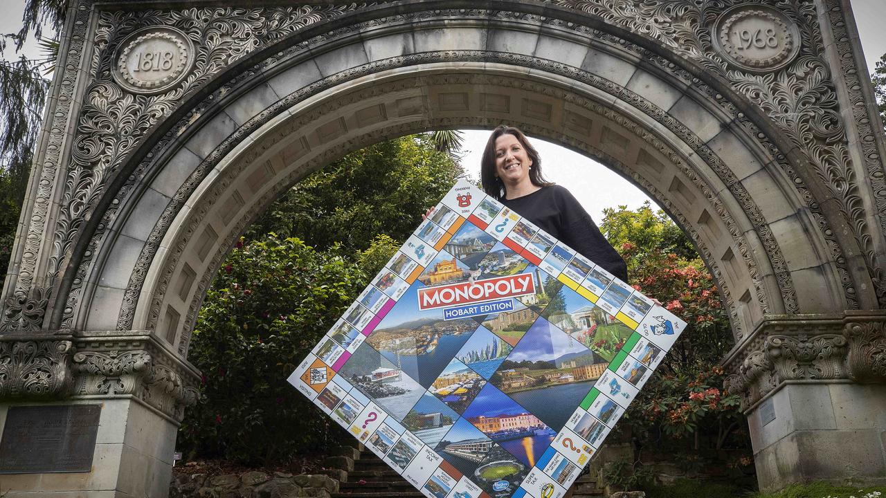 Royal tasmanian Botanical Gardens business enterprise an marketing manager Leesa Butler with a poster of the Monopoly Hobart board game. Picture: Chris Kidd
