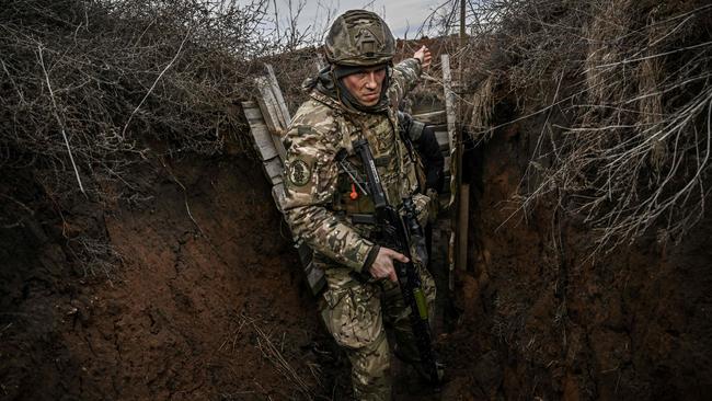 Ukrainian troops patrol at the frontline outside the town of Novoluhanske, eastern Ukraine, over the weekend. Picture: AFP