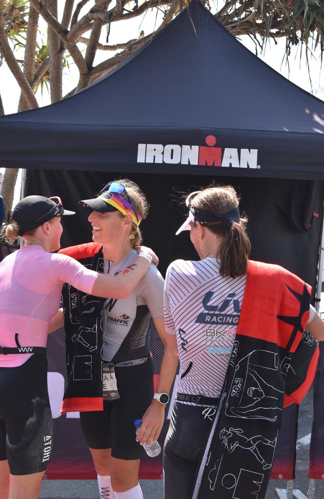 Rebecca Clarke, Radka Kahlefeldt and Sophie Perry at the finish line at the Sunshine Coast Ironman 70.3 2023.