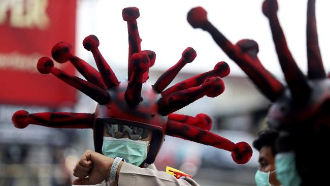 East Java police sport coronavirus helmets. Picture: AP