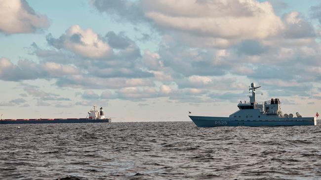 A naval patrol vessel monitors the bulk carrier Yi Peng 3 (L). Picture: AFP.