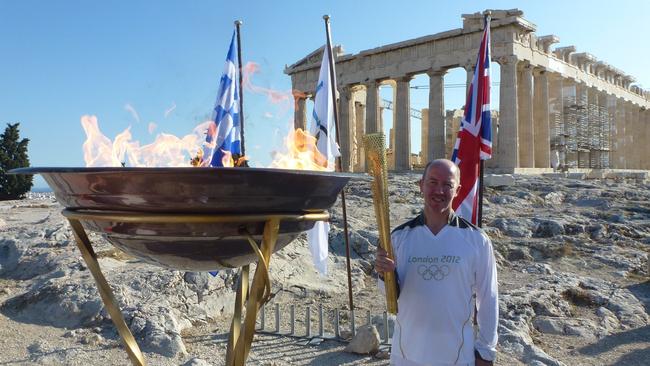 Olympic guru Michael Payne in Green with the Olympic torch ahead of the 2012 Olympics Pictures: supplied by Michael Payne.