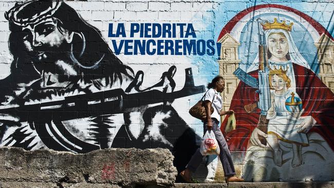 Street art in Caracas, Venezuela. Even Jesus carries a gun.