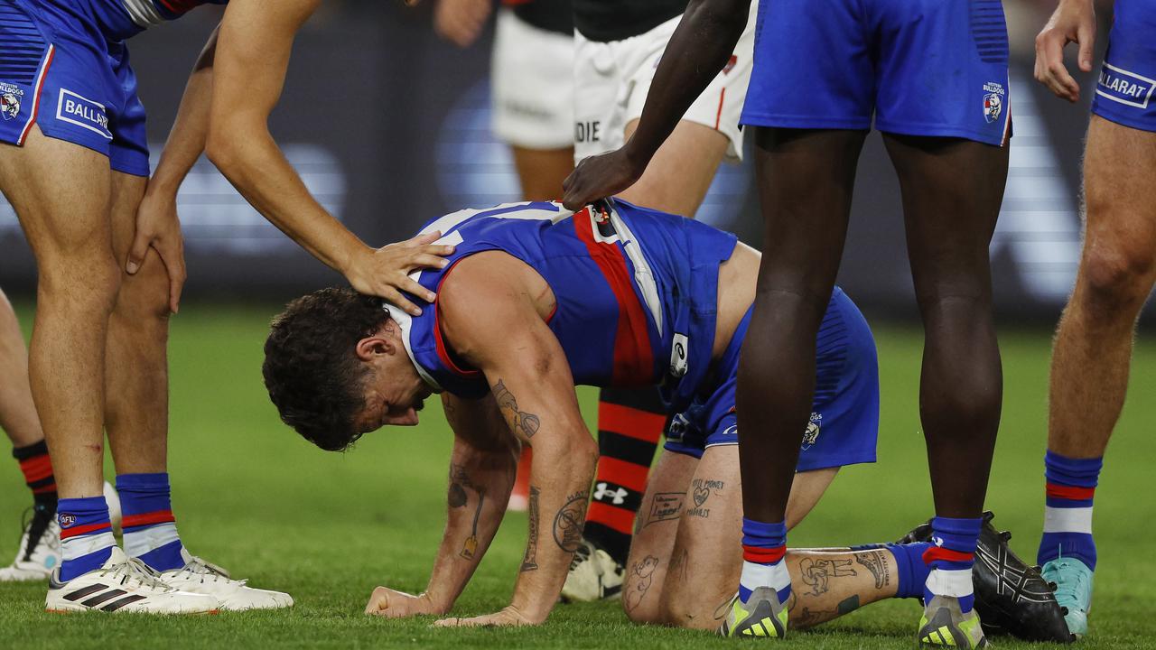 Tom Liberatore eventually entered the concussion protocols after he fell to the ground moments after a heavy collision during the Bulldogs’ loss to Essendon on Friday. Picture: Michael Klein