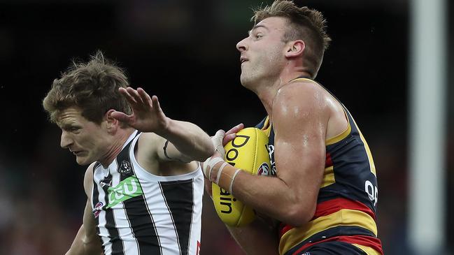 Adelaide’s Daniel Talia marks over Collingwood’s Will Hoskin-Elliott in Round 22. Picture: SARAH REED