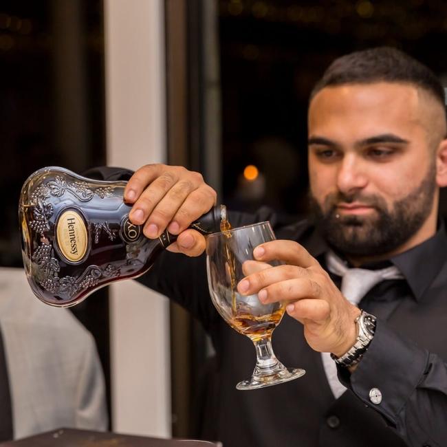 Sayet Erhan Akca pouring Hennessy. Akca is a fugitive alleged to be behind the “terror caravan plot” before fleeing Australia, after being charged with alleged drug importation offences. Picture: Facebook