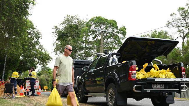 Residents collect sandbags at a Lota depot. Picture: Albert Perez