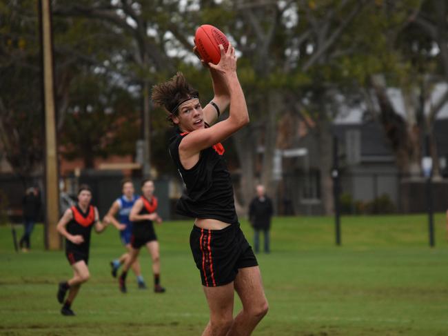 Rostrevor footballer and Australian under-19 cricketer Kyle Brazell marks against Sacred Heart. Picture: Sam Hearn