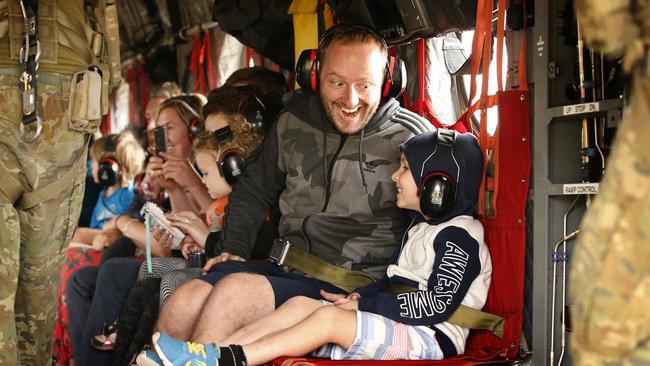 A father and son jubilant that they are finally leaving Mallacoota before take off. Picture: David Caird