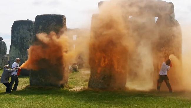 An image grab from a video released by the Just Stop Oil climate campaign group shows activists spraying an orange substance at Stonehenge in Wiltshire, southwest England. Picture: Handout / Just Stop Oil / AFP