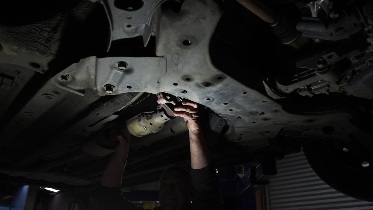 A Geelong mechanic demonstrates where a catalytic converter part is stolen from. The crime has been on the rise in Geelong. Photo: David Smith.