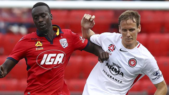 Adelaide United’s Baba Diawara (left) challenges Western Sydney Wanderers defender Michael Thwaite.