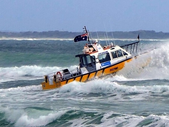 Noosa Coast Guard vessel John Waddams crossing the bar after a week of strong winds and big swells.