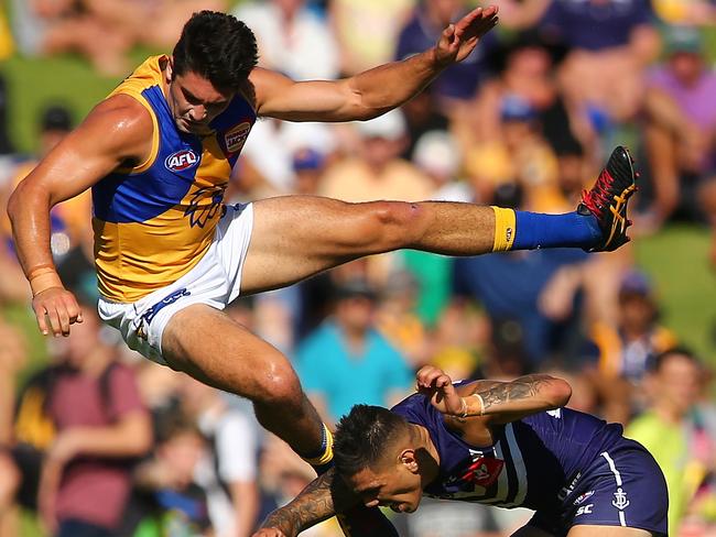 Tom Barrass is sent flying over Michael Walters. Picture: Getty Images