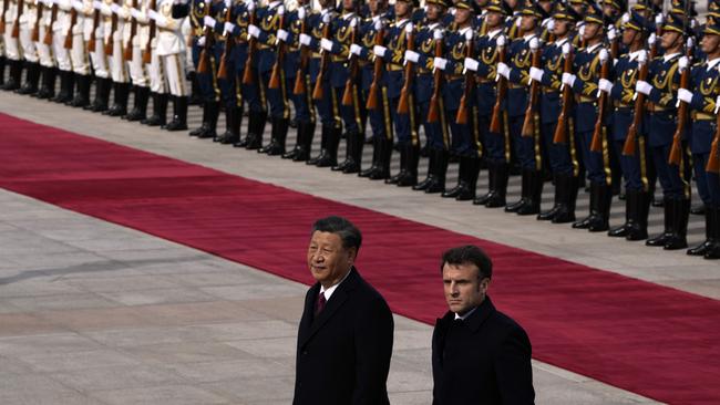 Macron walks with Xi after inspecting an honour guard in Beijing last week.