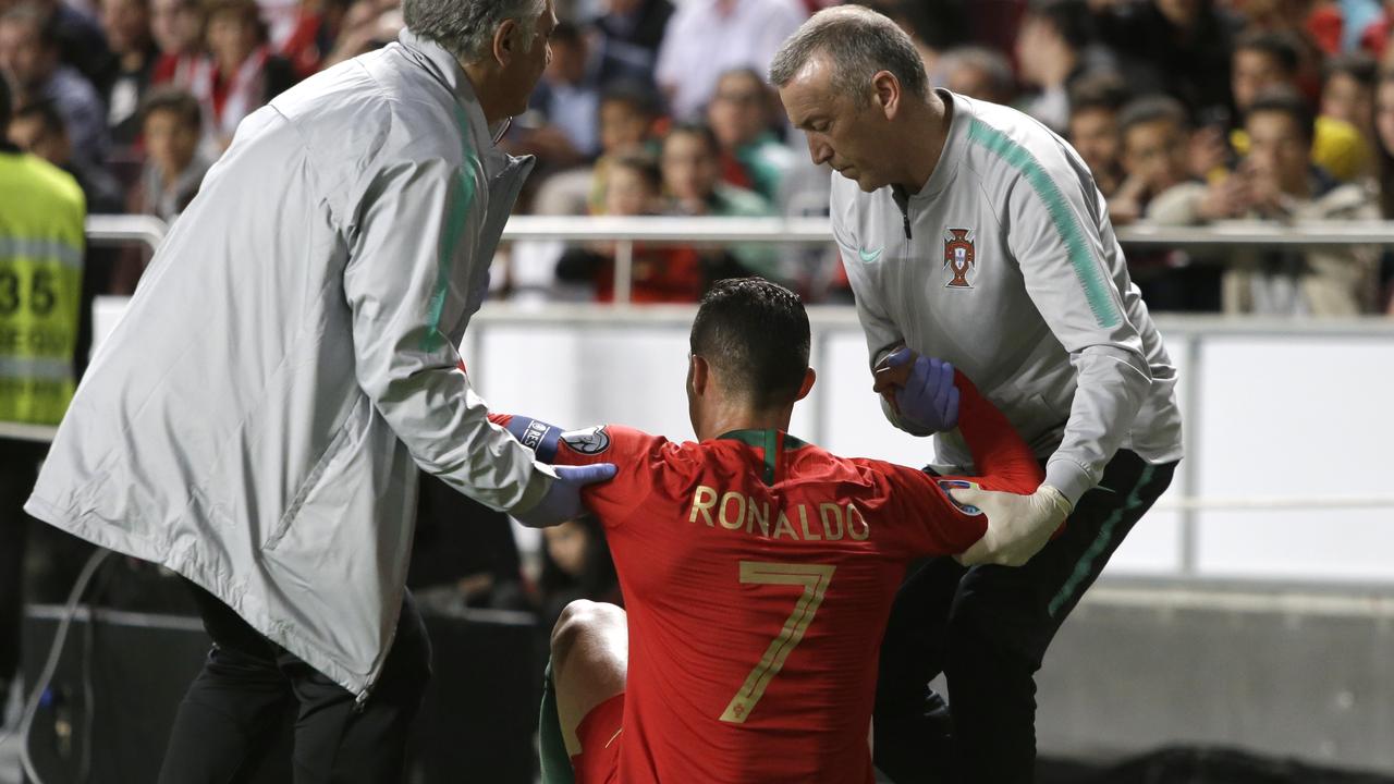 Cristiano Ronaldo receives treatment from medical staff
