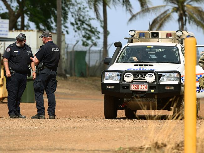 NT Police and Territory Resposnce Group (TRG) officers keep the peace as the community of Angurugu on Groote Eylandt mourns the death of two young males after they were killed by spears as feuding families fought with each other during a mass riot.