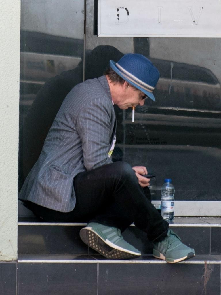 The actor later sat in front of an empty store for a cigarette break. Picture: Backgrid