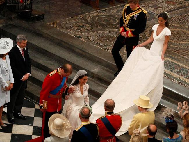 Nice save: Kate curtsies to the Queen at the conclusion of her wedding to Prince William. Picture: Getty