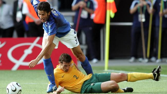 PIRATE: JUNE 26, 2006 : Italian defender Fabio Grosso falls after fighting for the ball with Australian defender Lucas Neill during the round of 16 World Cup football match between Italy and Australia at Kaiserslautern's Fritz-Walter Stadium, Germany, 26/06/06. A/CT